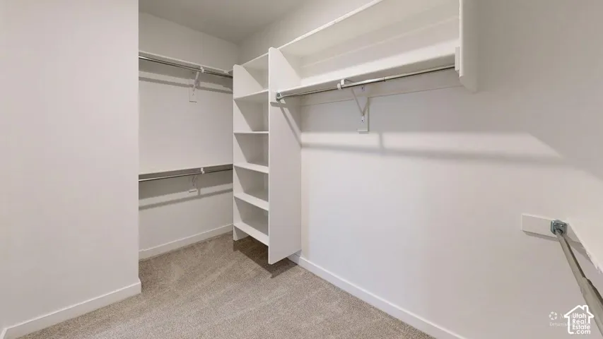 Integrated shelving system, multiple hanging rods, and neutral-toned carpeting