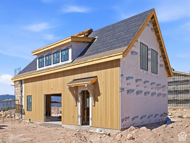Vertical wood-panel siding and stone veneer accents