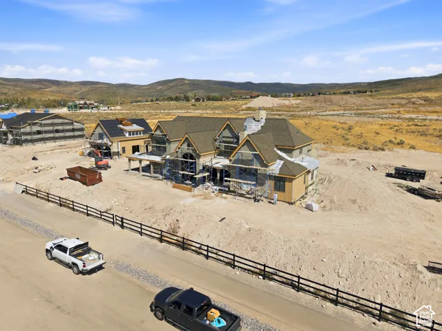New construction property with a multi-gabled roofline and a partial stone facade