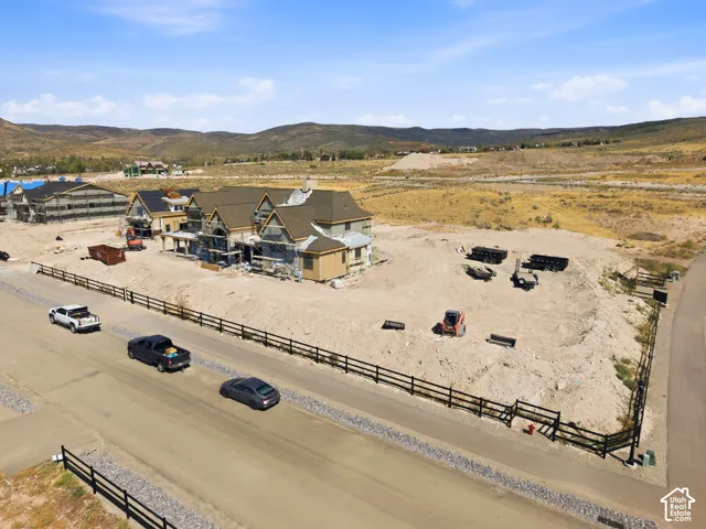 New construction property featuring multiple residences under development, a brown shingle roof, and exterior framing