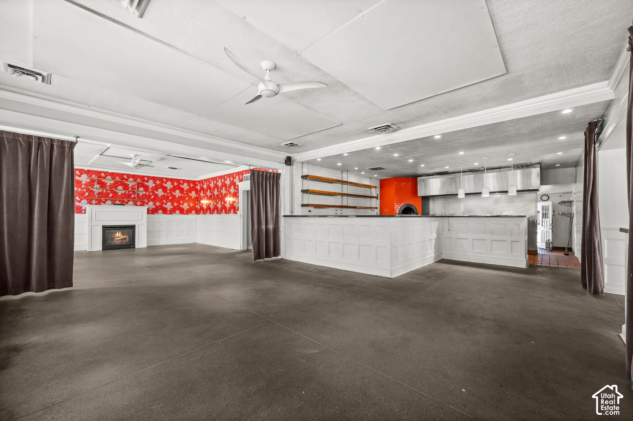 Spacious interior with dark flooring and white paneled walls
