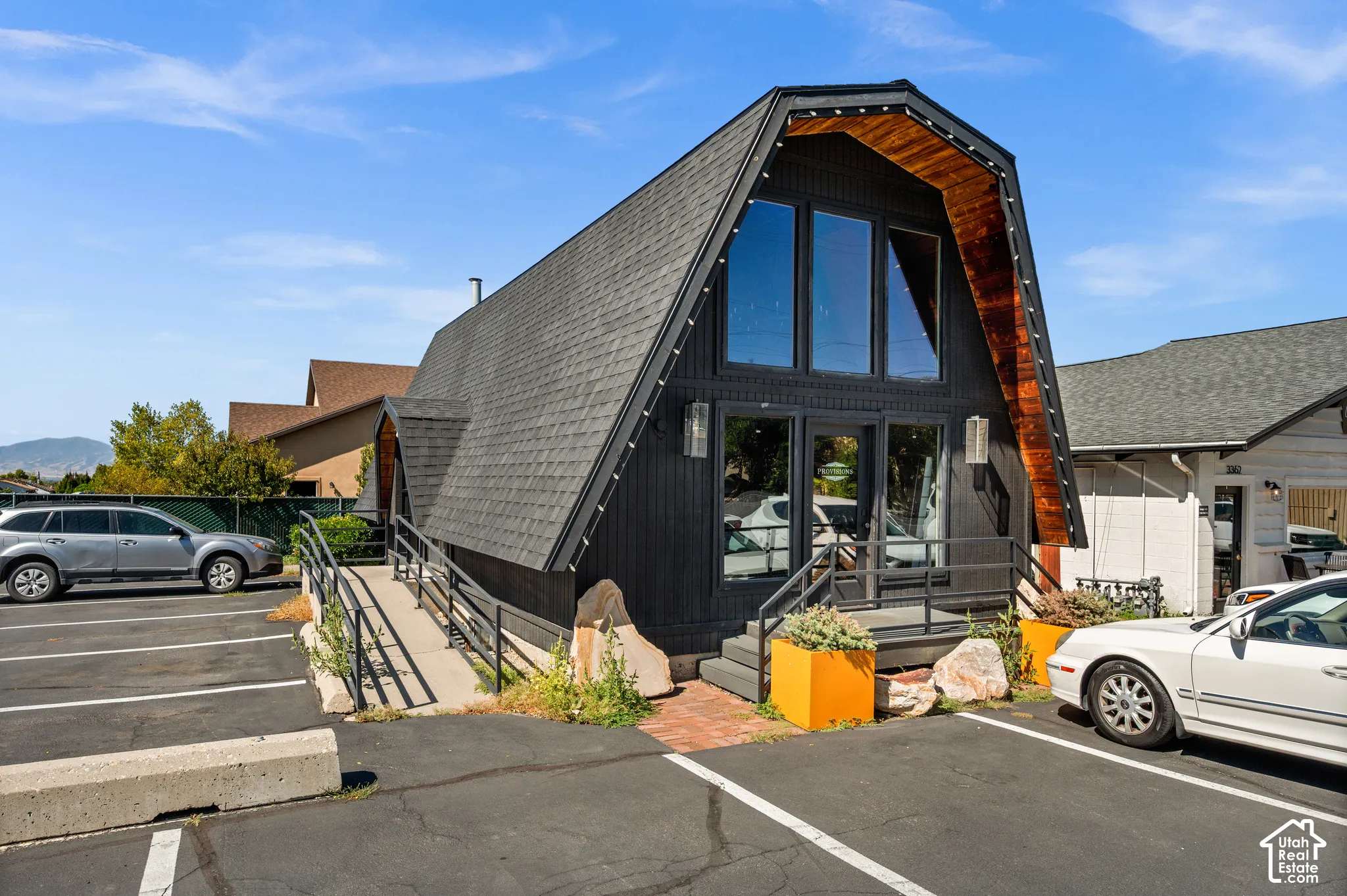 A-frame architectural style with a dark shingle roof and black siding