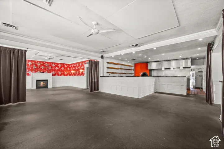 Spacious interior with dark flooring and white paneled walls