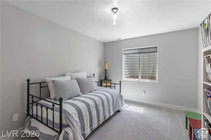 Recessed window, built-in shelving, carpet flooring, overhead lighting