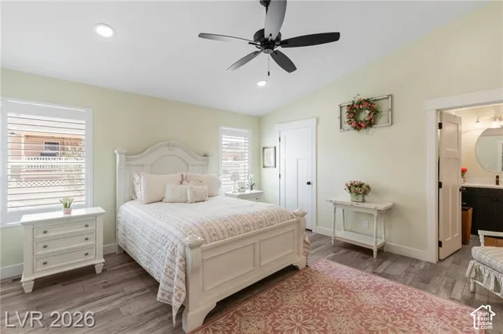 Vaulted ceiling with recessed lighting and a ceiling fan, wood-finish flooring, and white plantation shutters