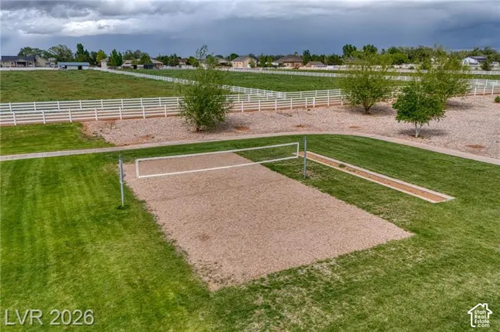 Sand volleyball court with a grass perimeter and dedicated approach area