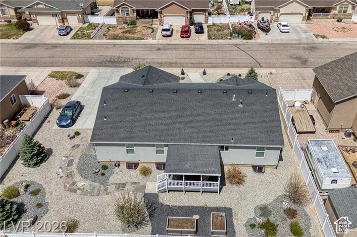 Pitched shingle roof over a multi-level structure with a covered back patio