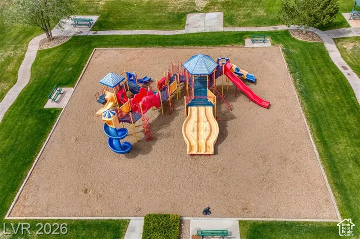 Community playground featuring multiple slides and climbing structures on a sand base