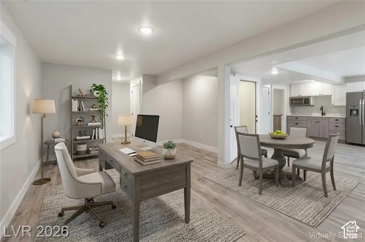 Recessed lighting illuminates the space, featuring wood-finish flooring throughout