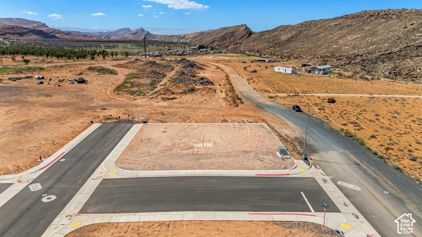 Cleared lot with established paved road frontage and concrete sidewalks