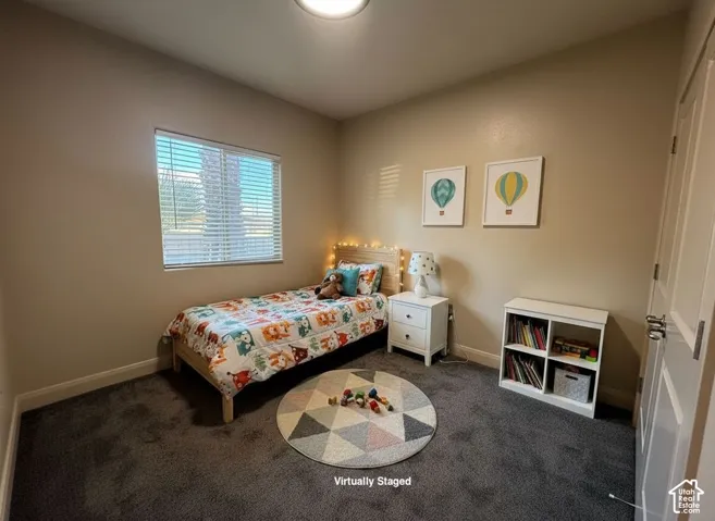 Wall-to-wall carpeting and a single window with blinds