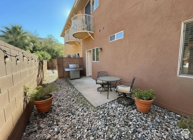 Stucco exterior with two balconies featuring decorative railings