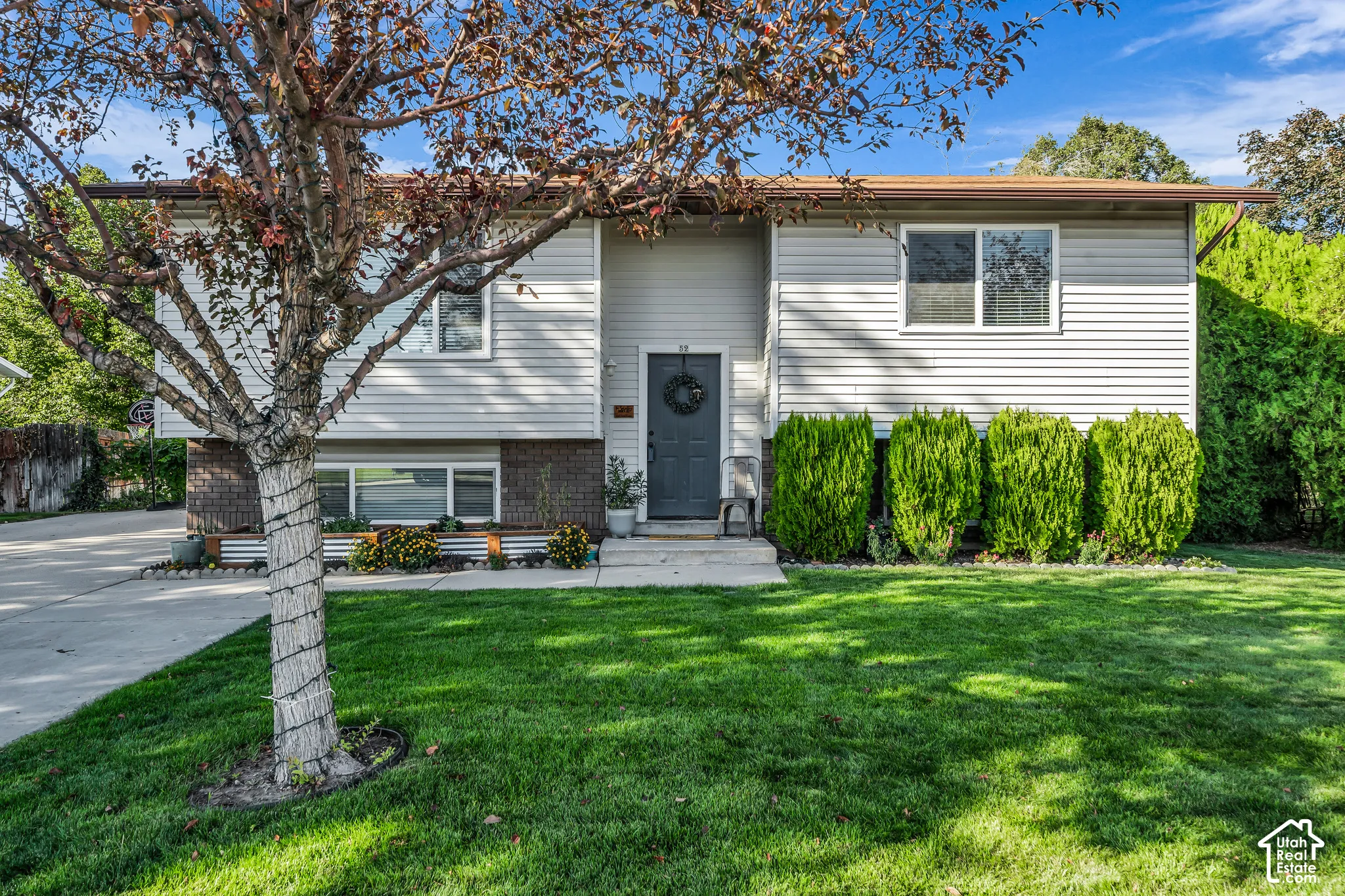 Split-level exterior featuring light-colored siding and brick accents