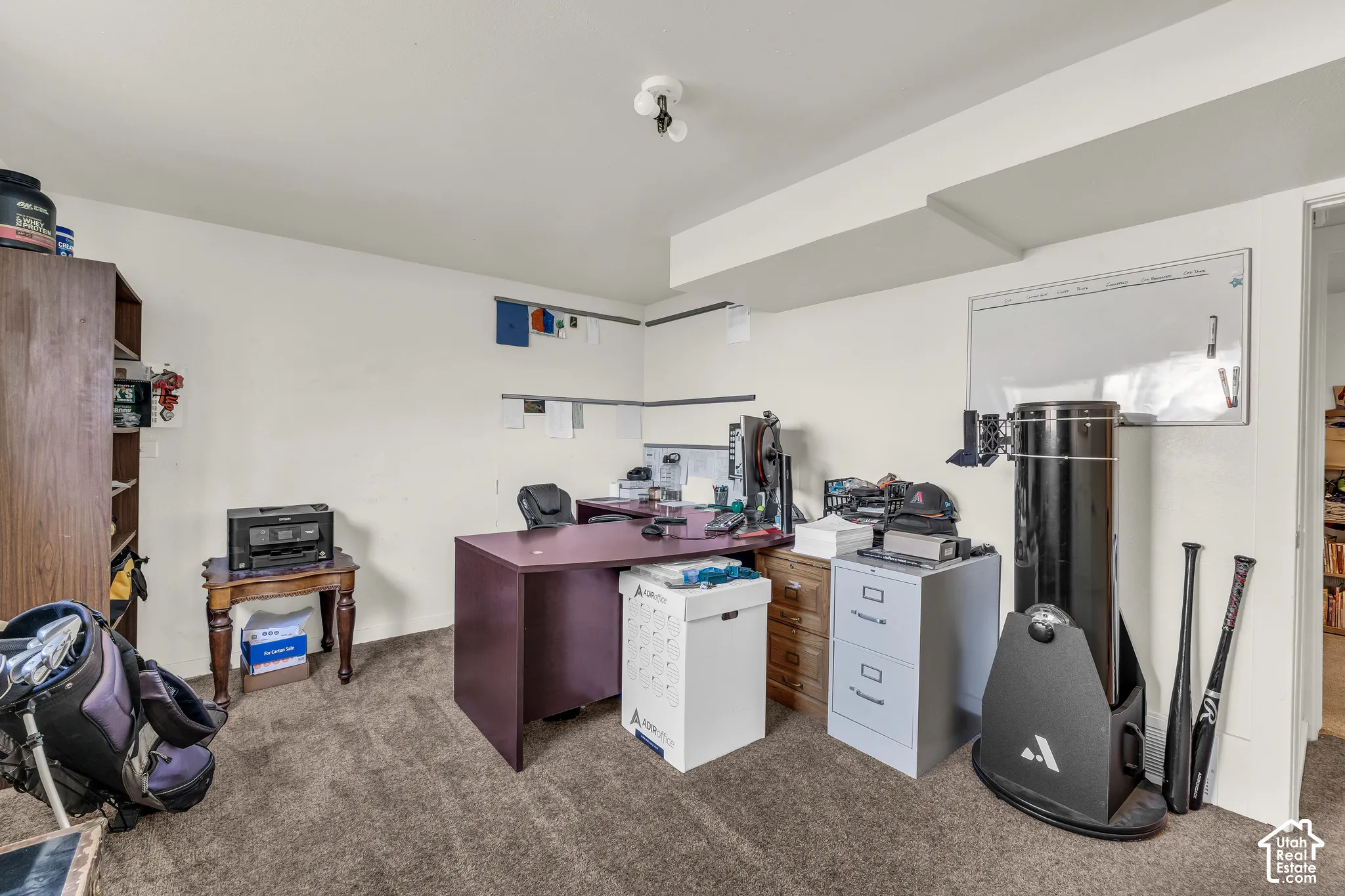 Bedroom currently used as an office space with attached half bathroom