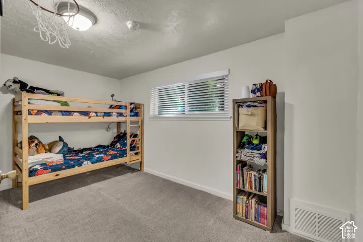 Neutral wall paint, light gray carpeting, and a window with blinds