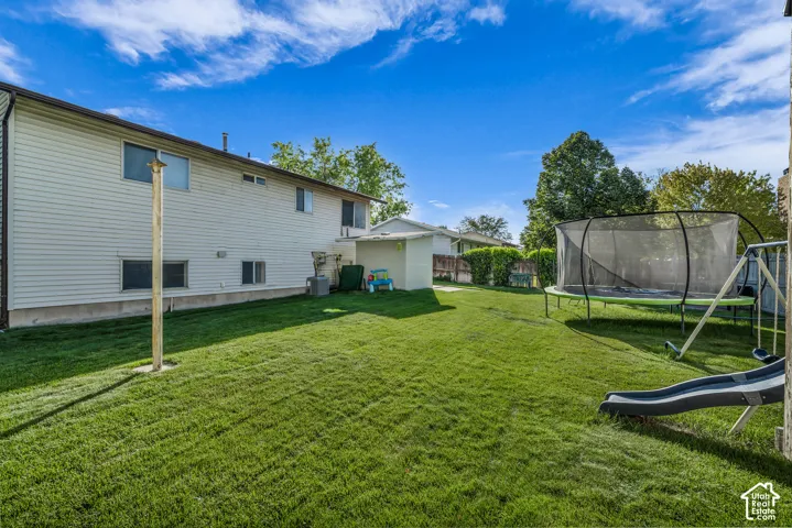 Expansive grassy yard with a storage shed