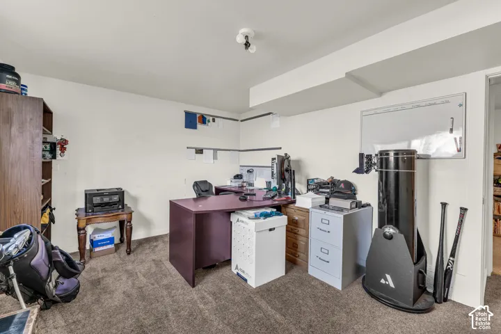 Bedroom currently used as an office space with attached half bathroom