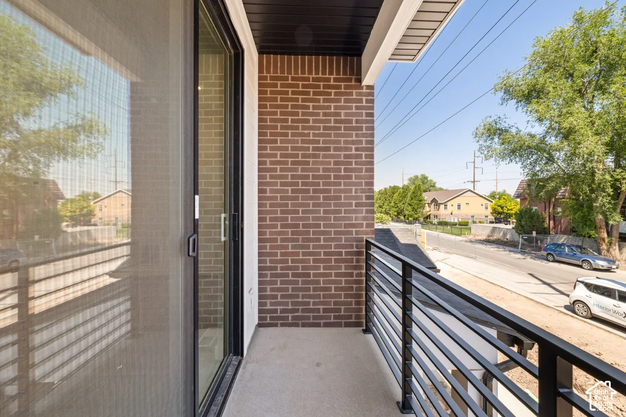 Balcony with concrete flooring and a black horizontal bar railing system