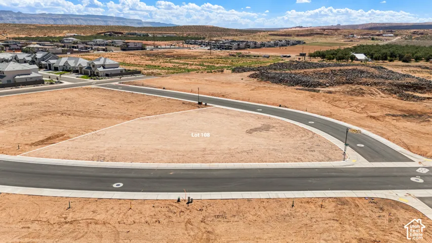 Level lot featuring paved road access and distant mountain backdrop