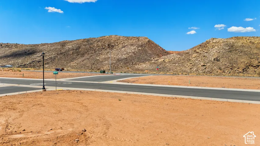 Paved streets, street light, and a mountainous backdrop