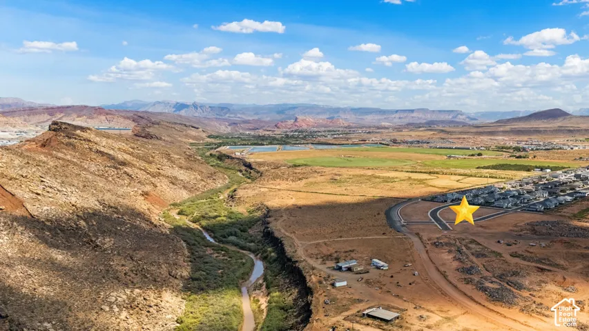 Expansive undeveloped land featuring a paved cul-de-sac and desert landscaping