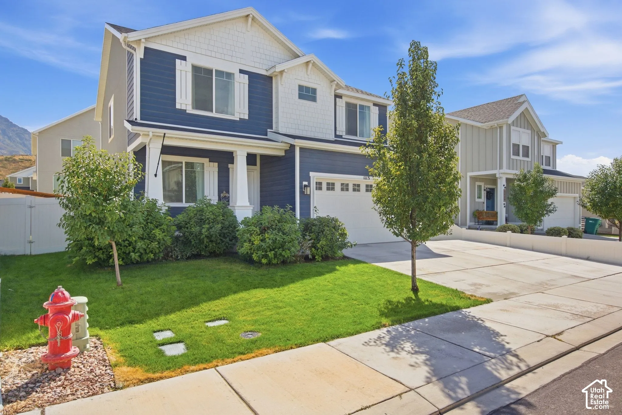 Two-story residence featuring blue siding, white trim accents, and a dual-pane window system