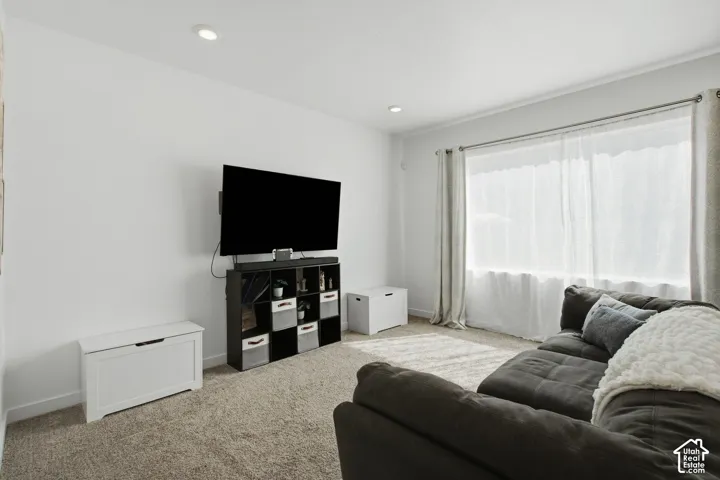 Recessed ceiling lighting, crown molding, wall-to-wall carpeting, and a large window