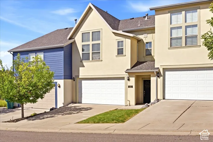 Multi-level stucco and siding exterior with multiple garage doors