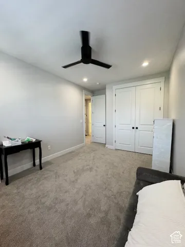 Recessed lighting, ceiling fan, and light gray wall paint