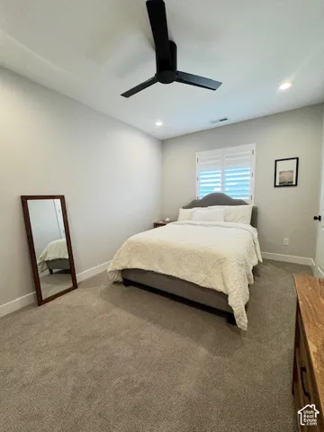 Recessed lighting, ceiling fan, carpeted flooring, window with plantation shutters, and painted walls