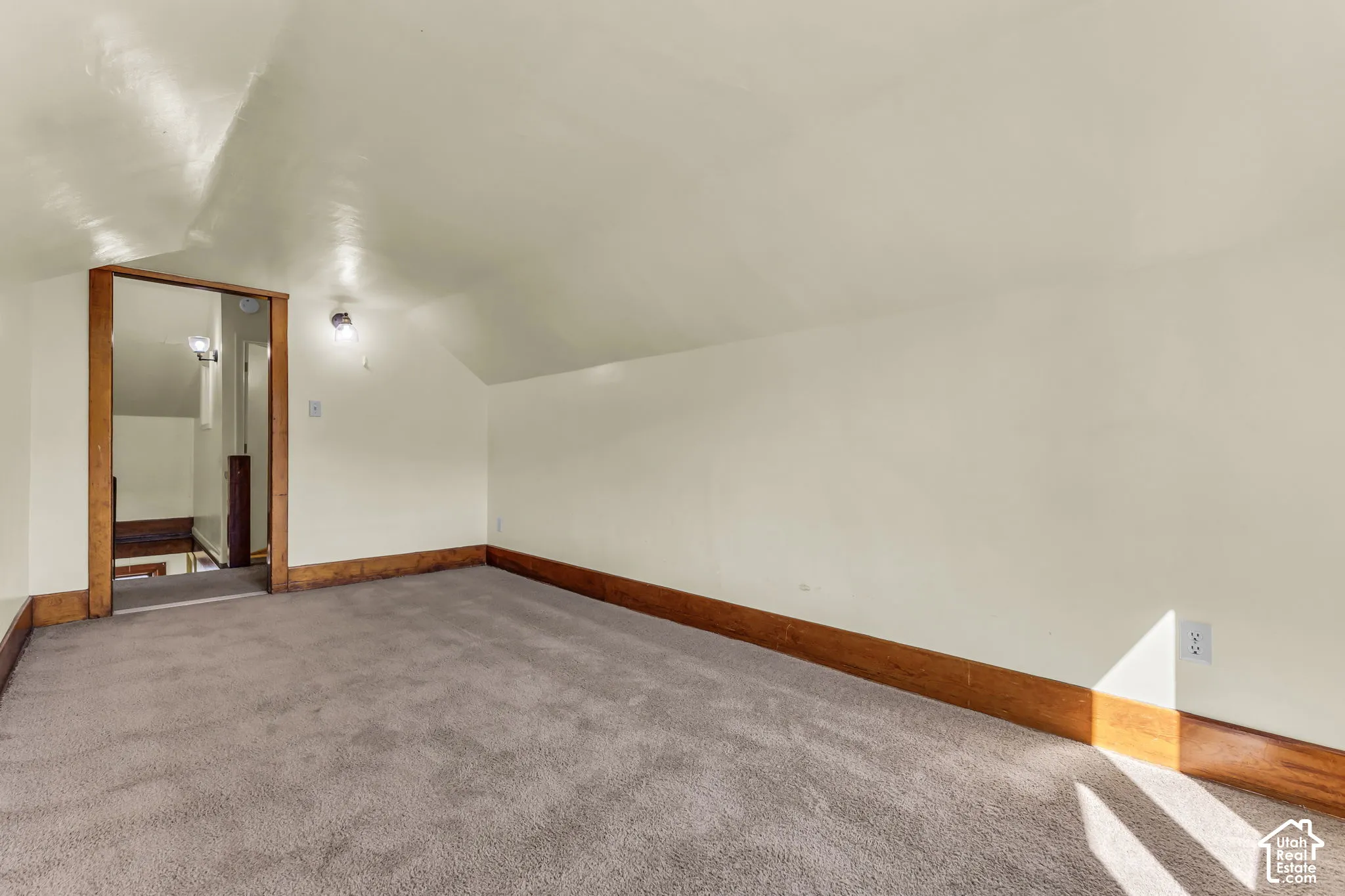 Carpeted flooring with wood trim and painted walls