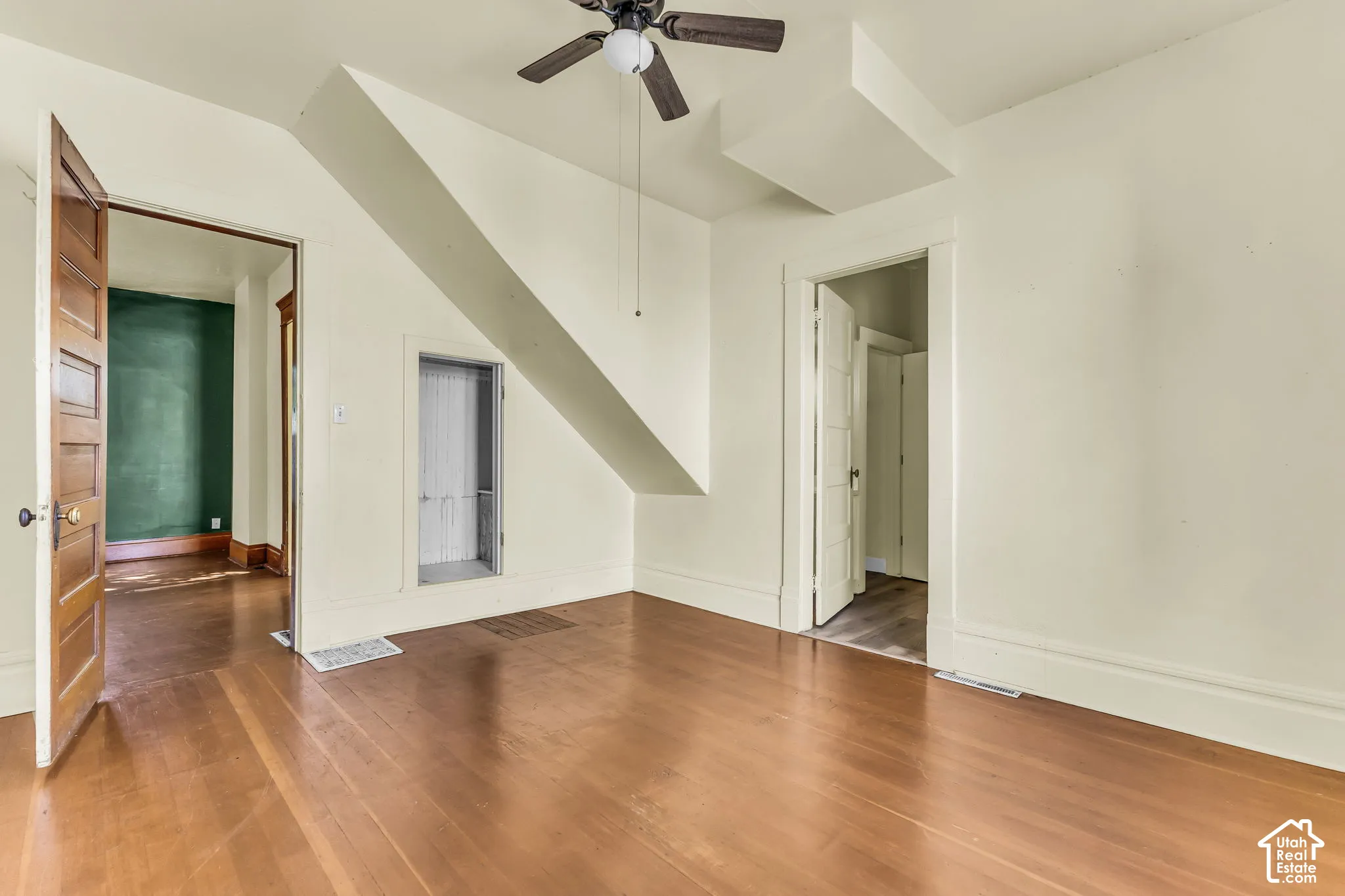 Hardwood flooring, ceiling fan, and multiple doorways