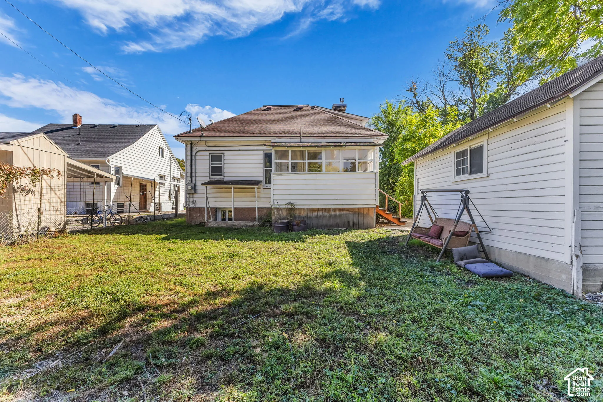 Expansive grassy yard with a detached structure