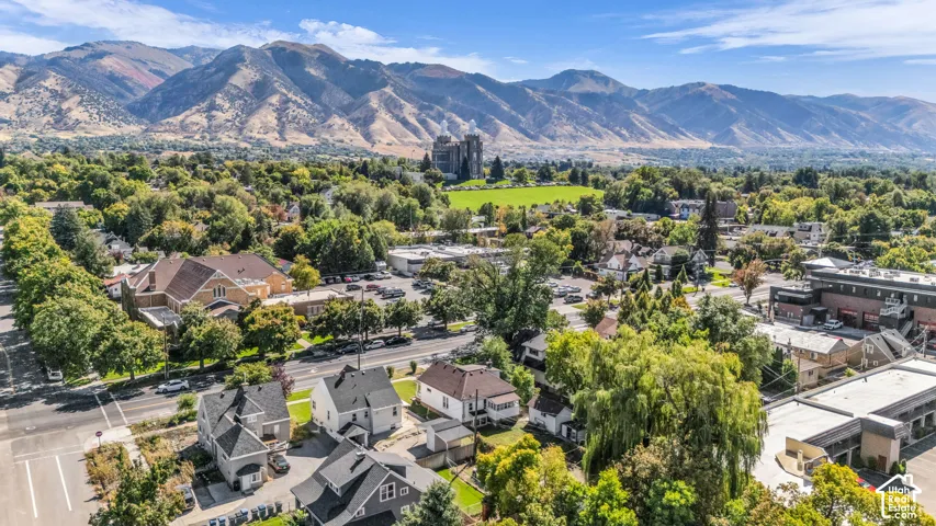 Mountain backdrop with expansive green spaces and established tree-lined streets