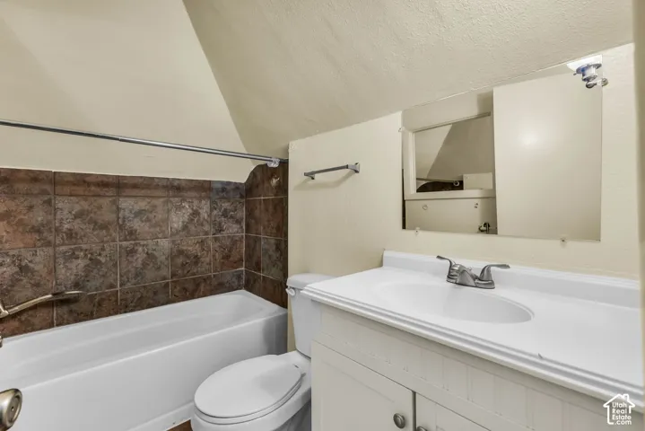 White vanity with integrated sink, chrome faucet, and mirrored medicine cabinet