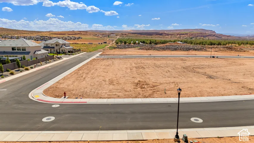 Paved streets with integrated curbs, streetlights, and visible utility access points