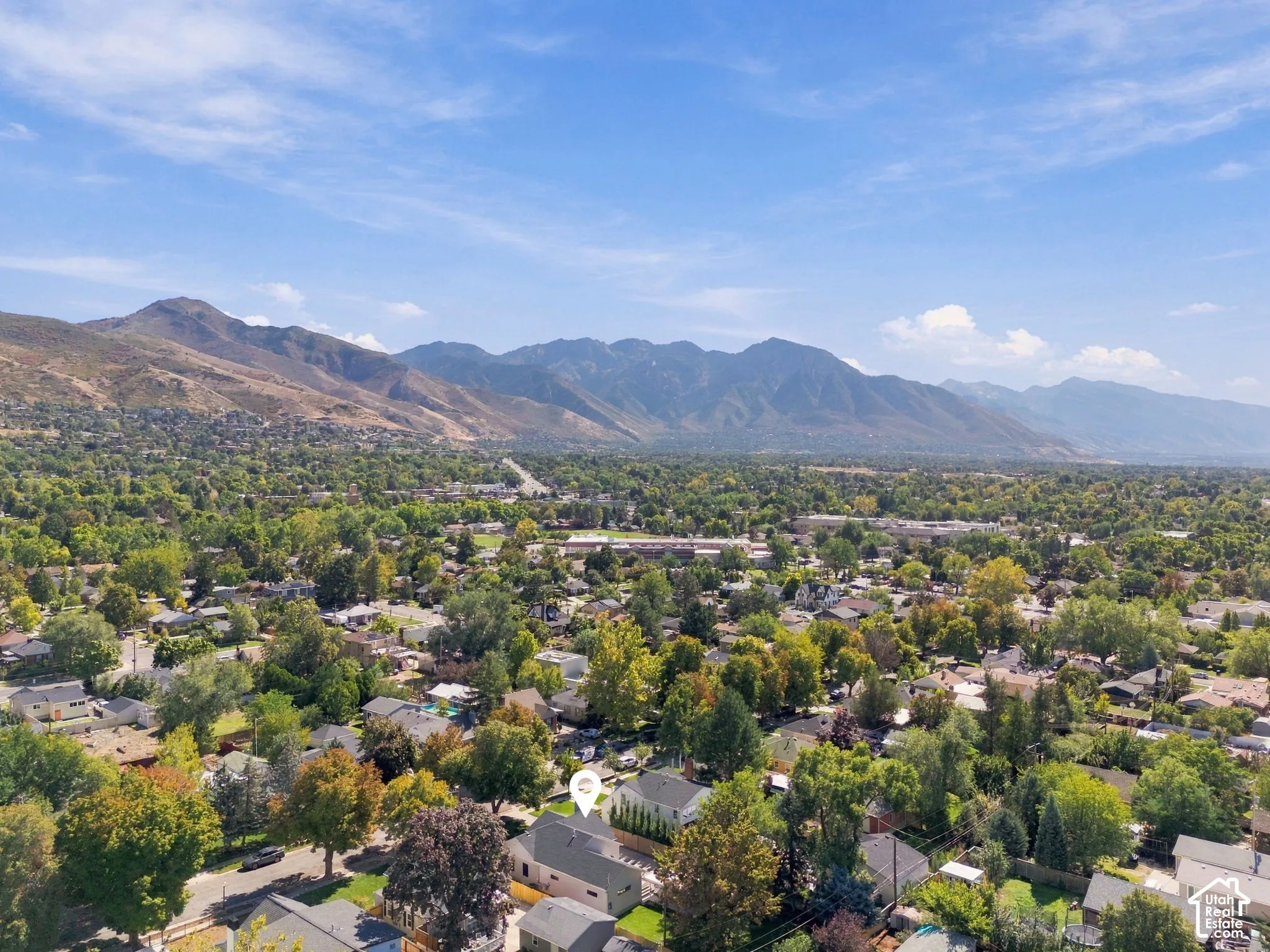 Expansive neighborhood with abundant mature trees and mountain backdrop