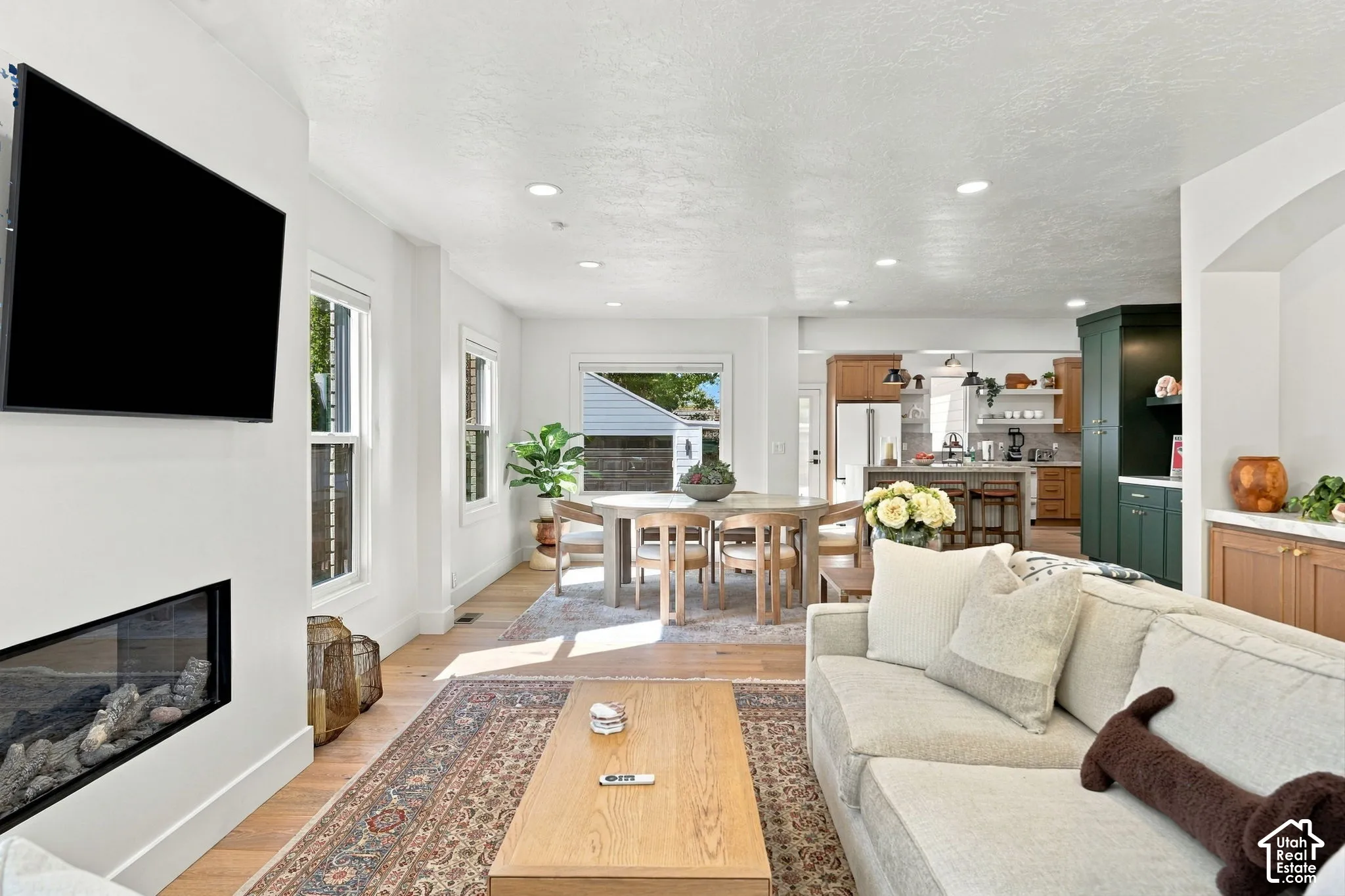 Hardwood-finish flooring, recessed lighting, and a linear fireplace