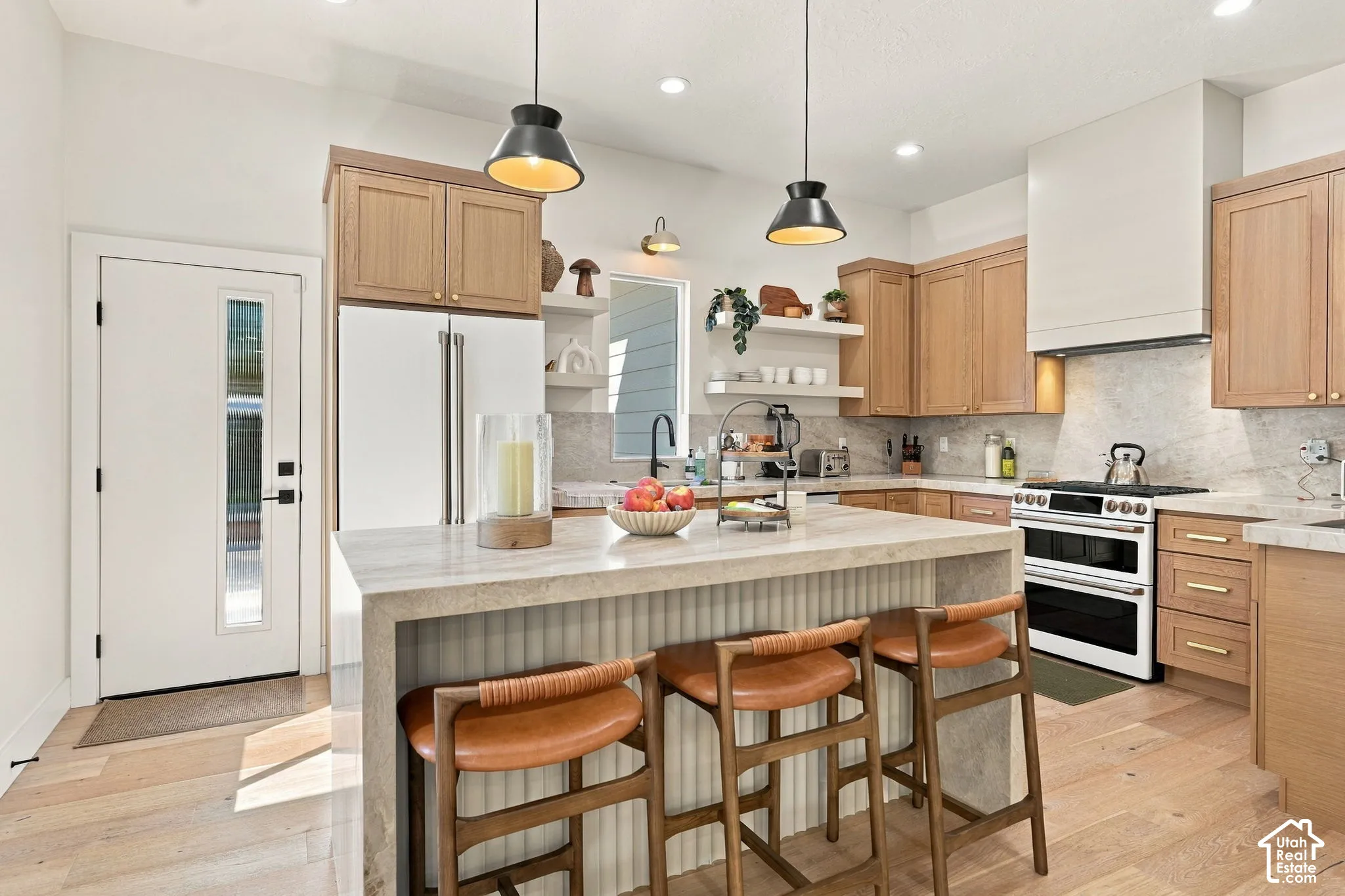 Gourmet kitchen featuring a center island, light wood-finish cabinetry, built-in range, and recessed lighting
