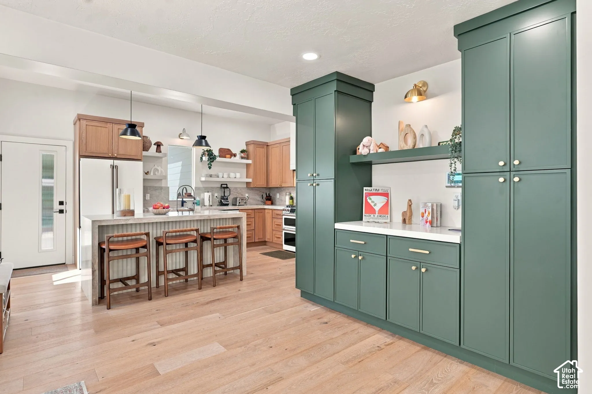 Light wood-finish flooring extending through the kitchen and dining areas