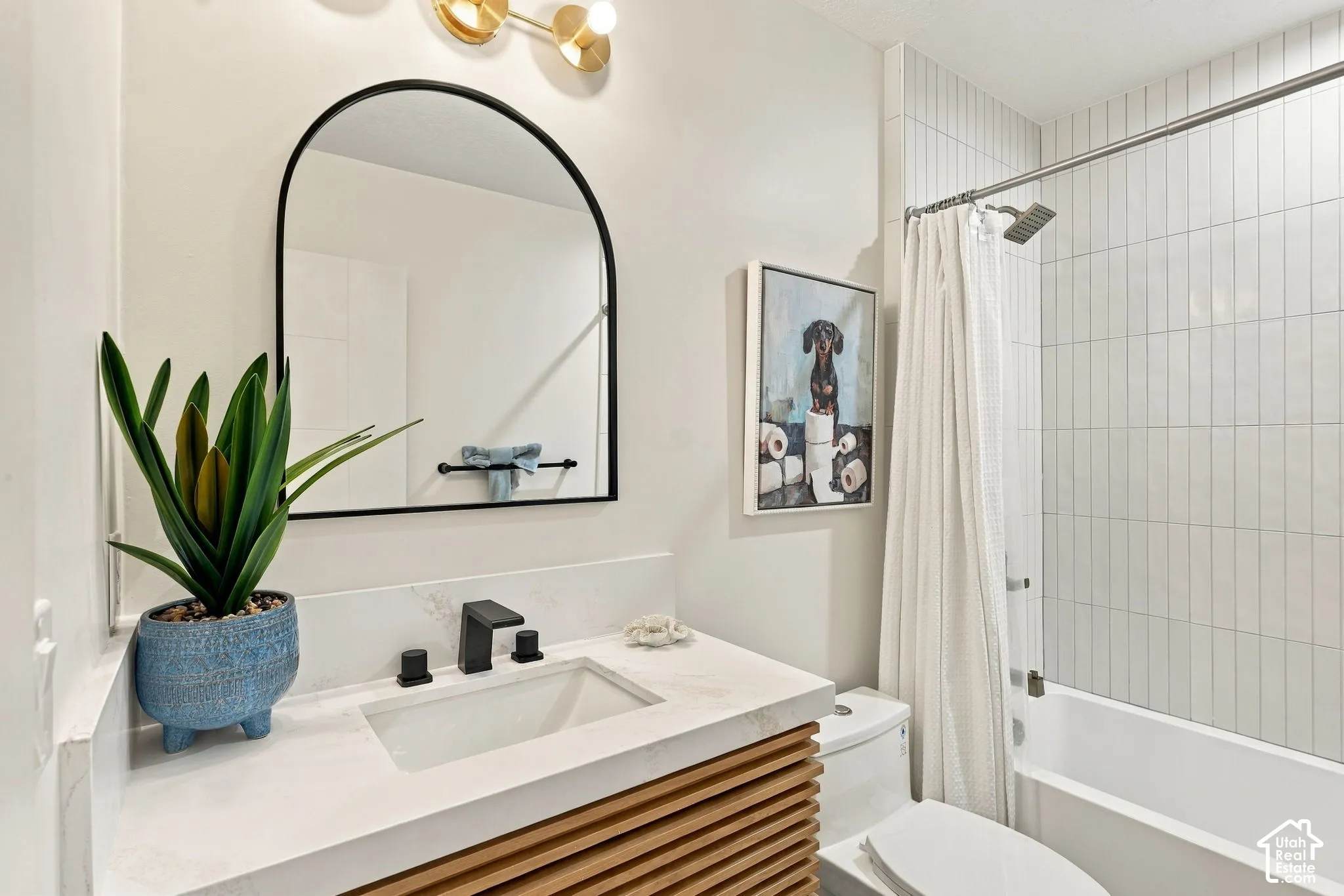 White subway tile shower surround with chrome fixtures, a built-in bathtub, and a modern vanity with a white countertop