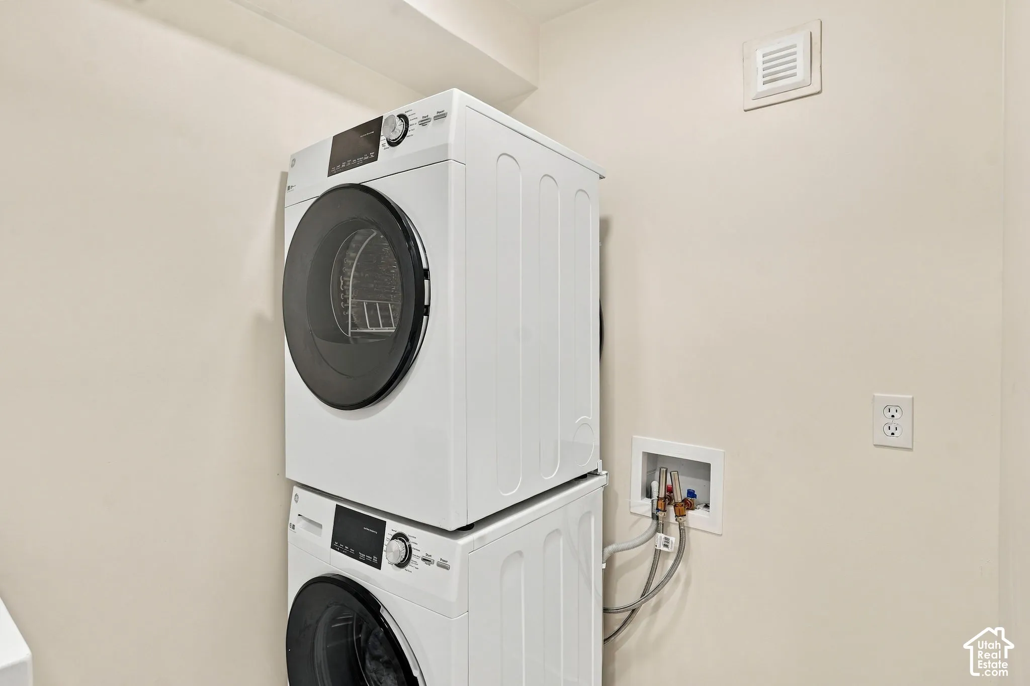 Stacked laundry appliances with a front-loading washer and dryer
