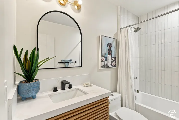 White subway tile shower surround with chrome fixtures, a built-in bathtub, and a modern vanity with a white countertop