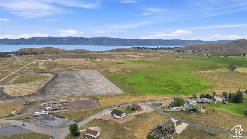 Expansive open land with a distinct water body and distant mountains
