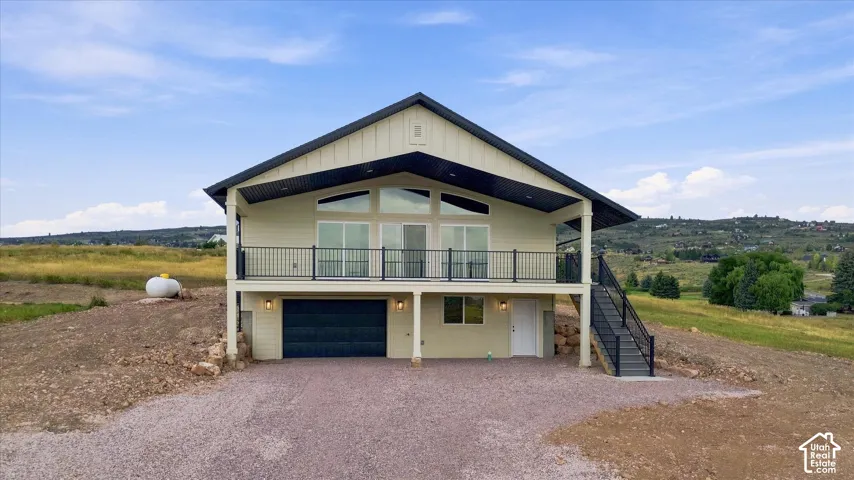 Contemporary exterior with a covered balcony and black metal railing
