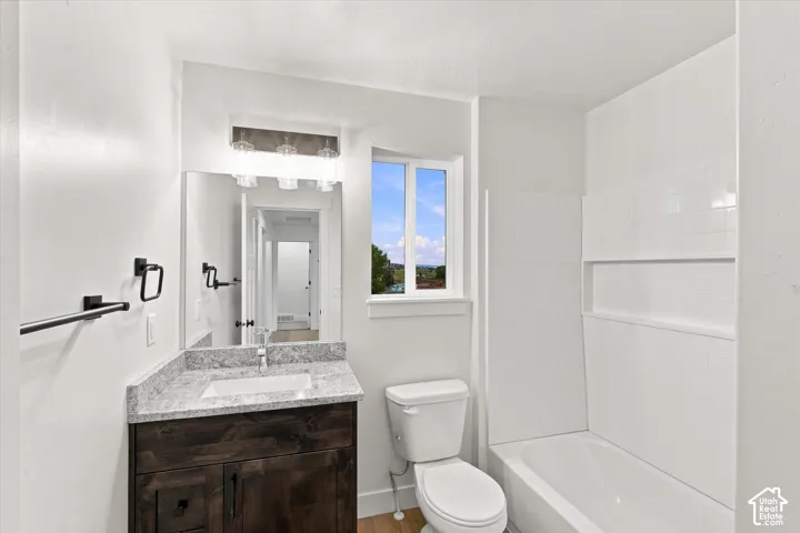 Wood-finish vanity with an undermount sink and stone-finish countertop