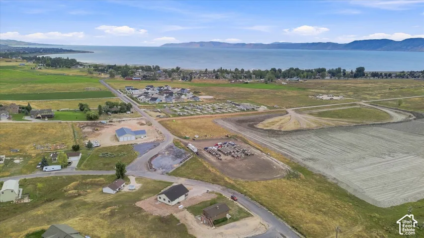 Expansive land parcel featuring existing roadways and distant water body