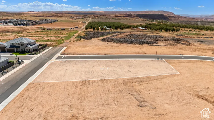 Expansive lot featuring a level building area, paved street access, and distant mountain backdrops