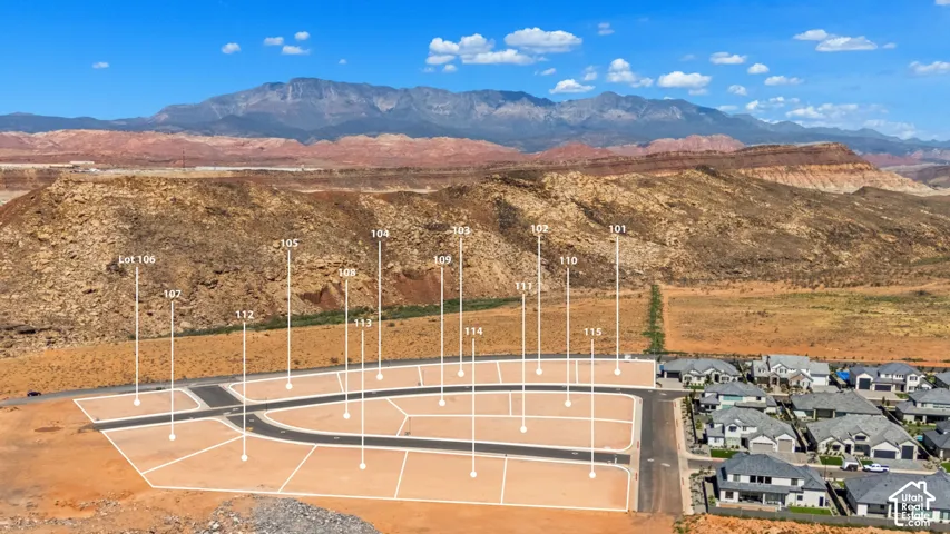 Developed lot subdivision with paved roads, surrounding residential structures, and mountain backdrop