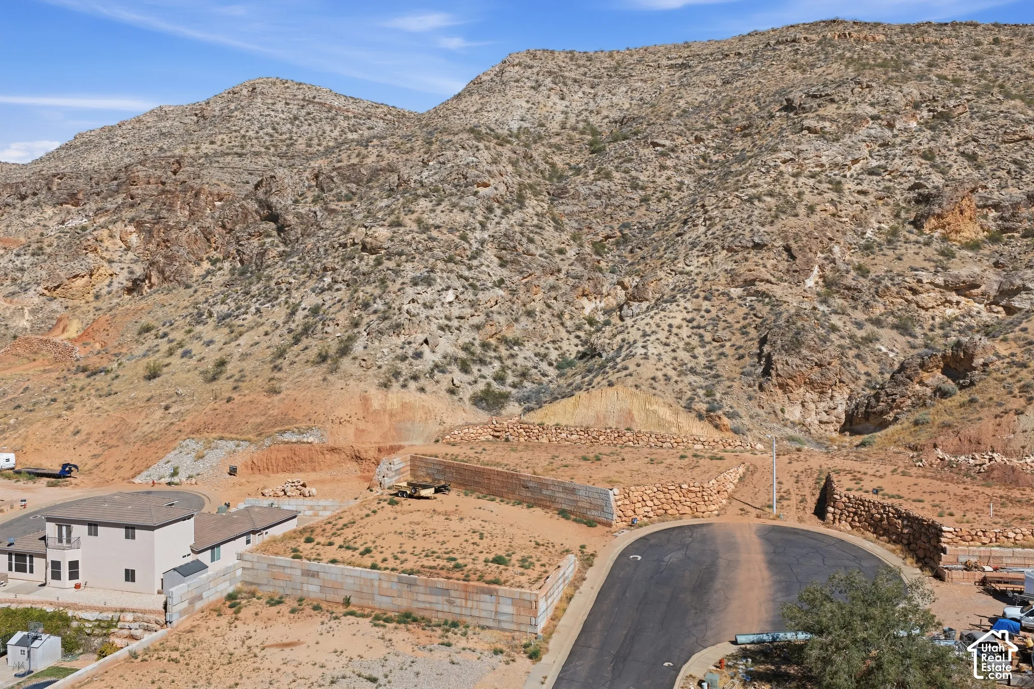 Expansive mountain terrain with visible rock formations and arid vegetation